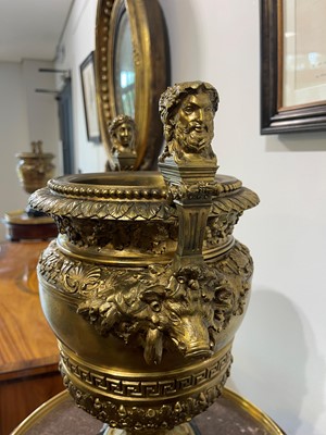 Lot 88 - A pair of neoclassical gilt-bronze urns