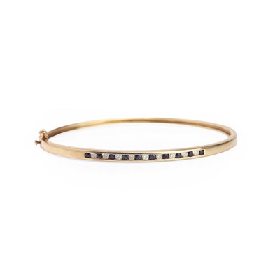 Lot 107 - A sapphire and diamond hinged bangle