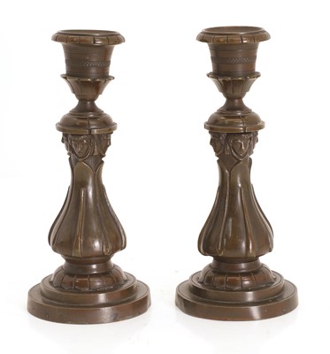 Lot 323 - A pair of bronze candlesticks