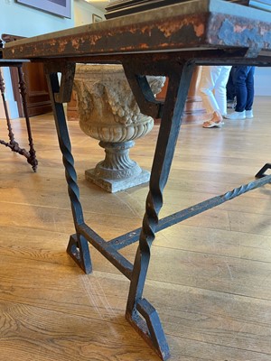 Lot 414 - An iron-framed limestone garden table