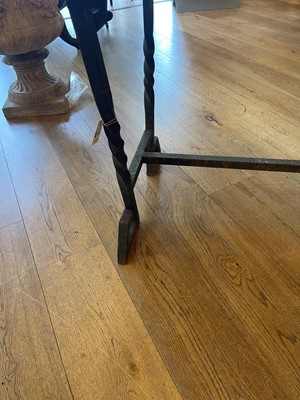 Lot 414 - An iron-framed limestone garden table