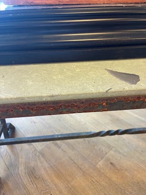 Lot 414 - An iron-framed limestone garden table