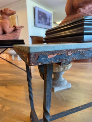Lot 414 - An iron-framed limestone garden table