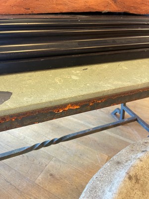Lot 414 - An iron-framed limestone garden table