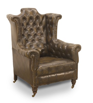 Lot 509 - A buttoned upholstered wing back library armchair