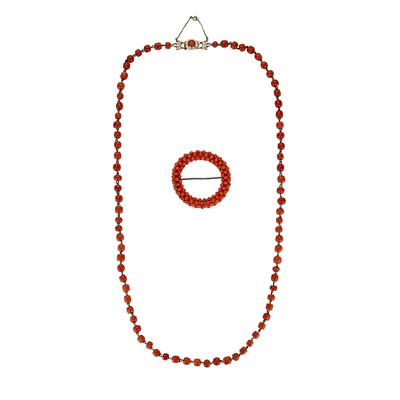 Lot 183 - A coral bead necklace and a circular buckle / ornament