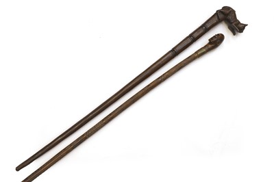 Lot 304 - A tribal carved walking stick and another carved with a cat