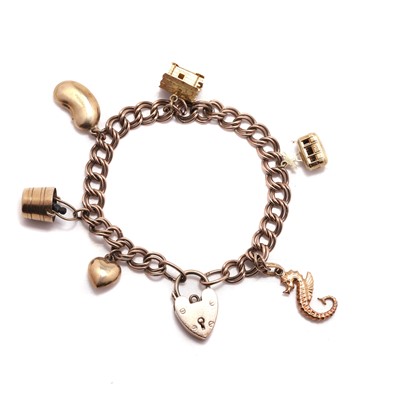 Lot 290 - A silver gilt bracelet suspending gold charms