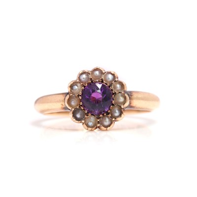 Lot 23 - An Edwardian amethyst and split pearl cluster ring
