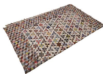 Lot 411 - A hand-sewn patchwork quilt