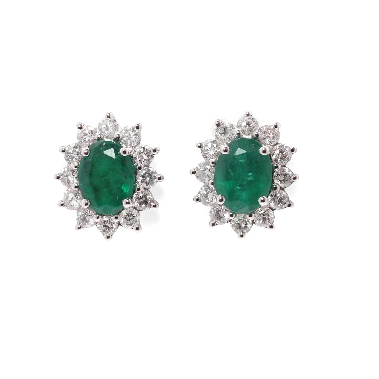 Lot 97 - A pair of 18ct white gold emerald and diamond earrings