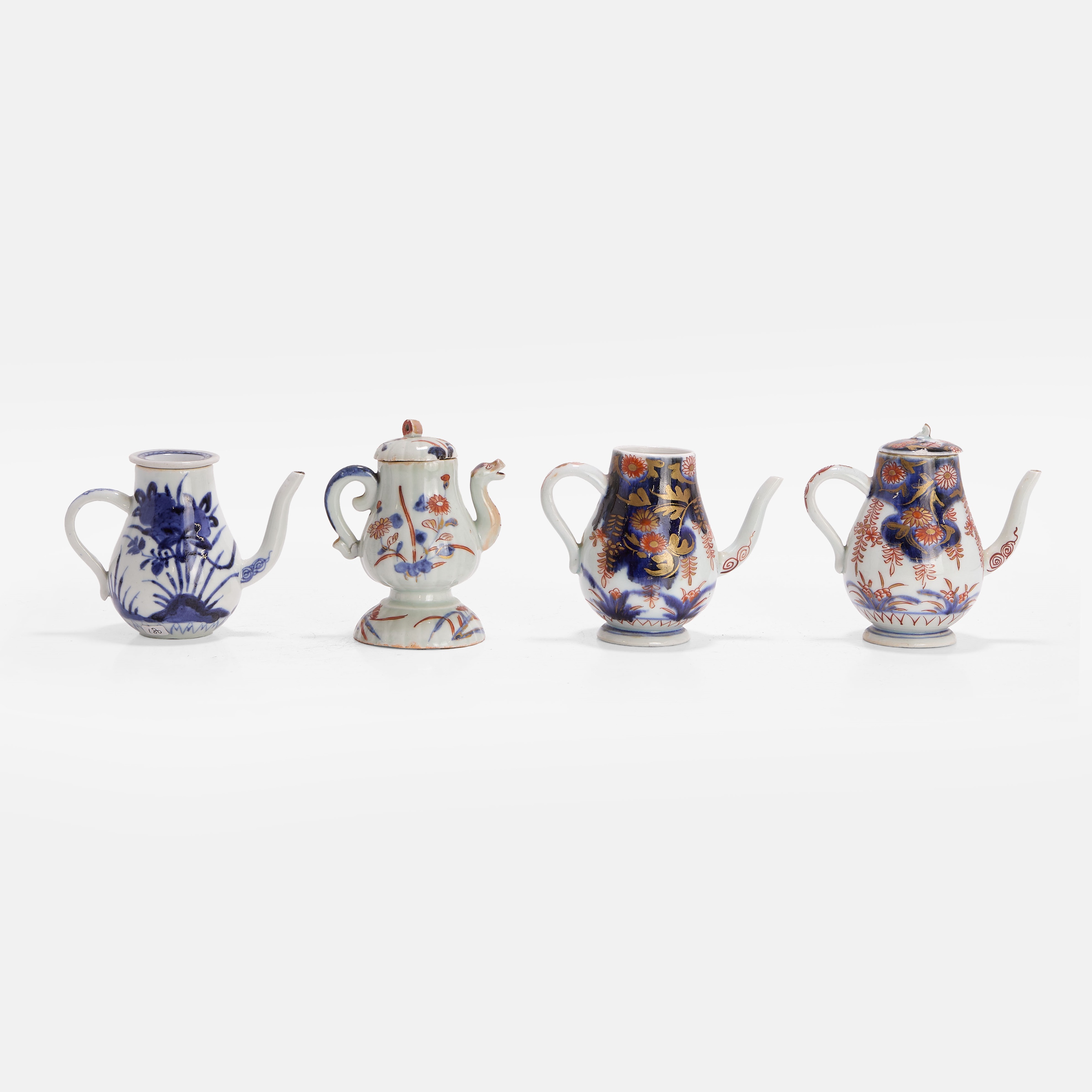 Lot 434 - Three Japanese Arita condiment ewers,