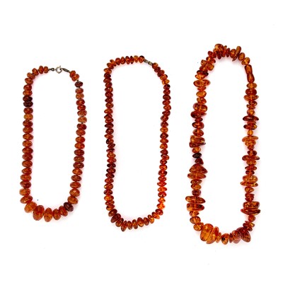 Lot 266 - A group of three clarified amber bead necklaces