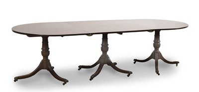 Lot 521 - A mahogany triple pillar dining table