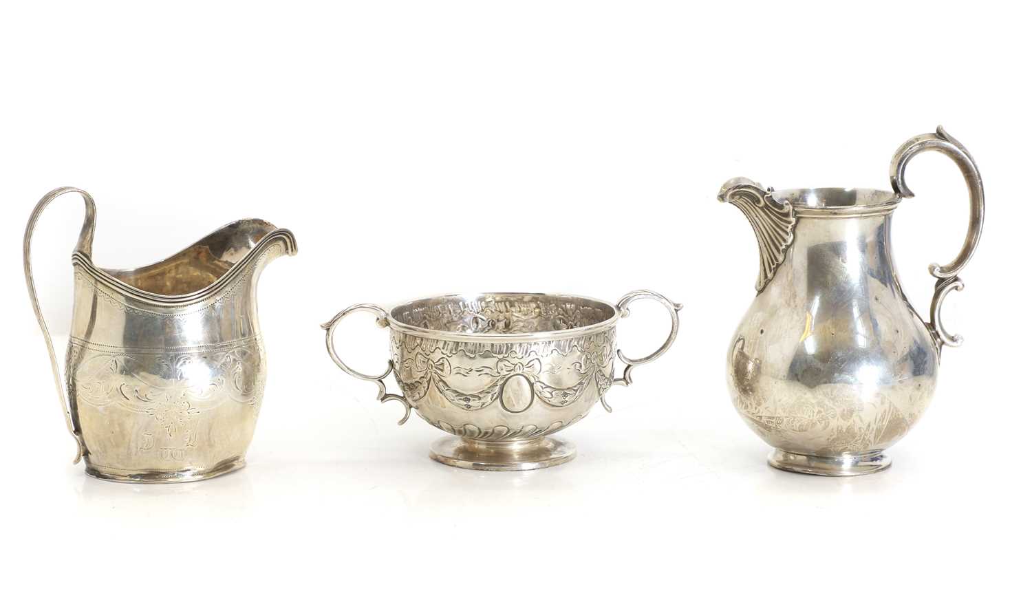 Lot 1 - Two silver cream jugs, and a twin-handled bowl