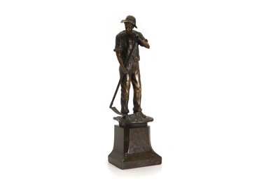 Lot 252 - A bronze figure of a man holding a scythe