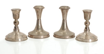 Lot 1 - A group of four silver dwarf candlesticks