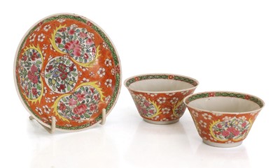Lot 59 - A Chinese coral and iron red-ground famille rose cup and saucer