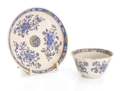 Lot 55 - A Chinese blue enamelled and gilt teacup and saucer