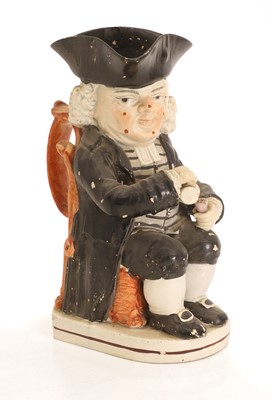 Lot 137 - An Enoch Wood type Drunken Parson (or Dr. Johnson) Toby jug